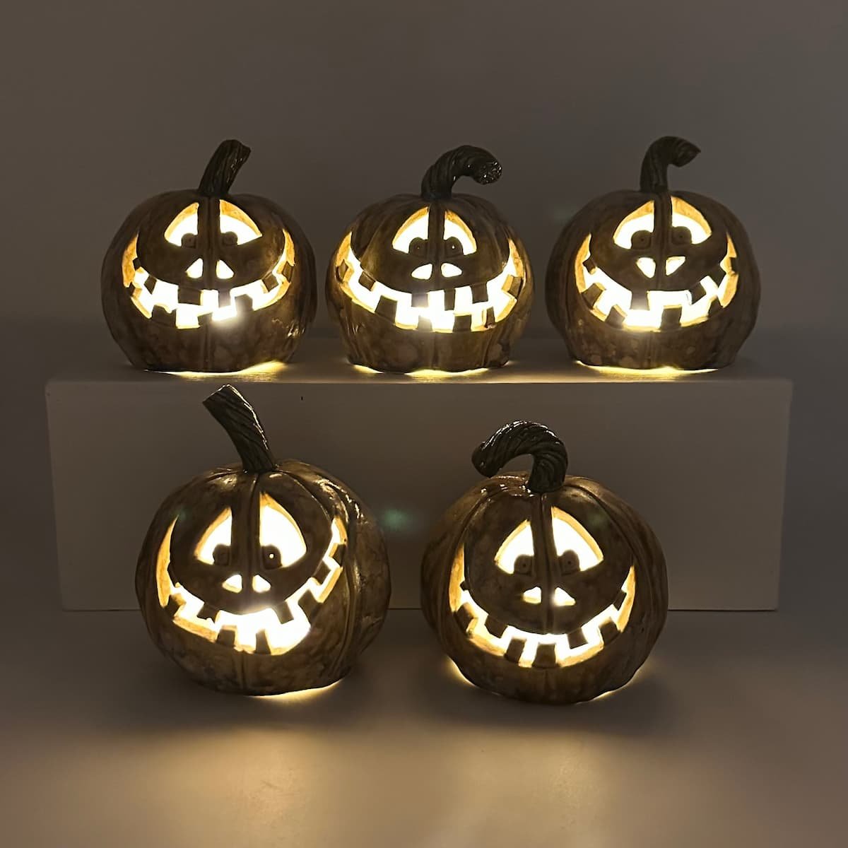 Carved ceramic pumpkin with battery tealight - group in the dark - Lucy Ormsby Pottery