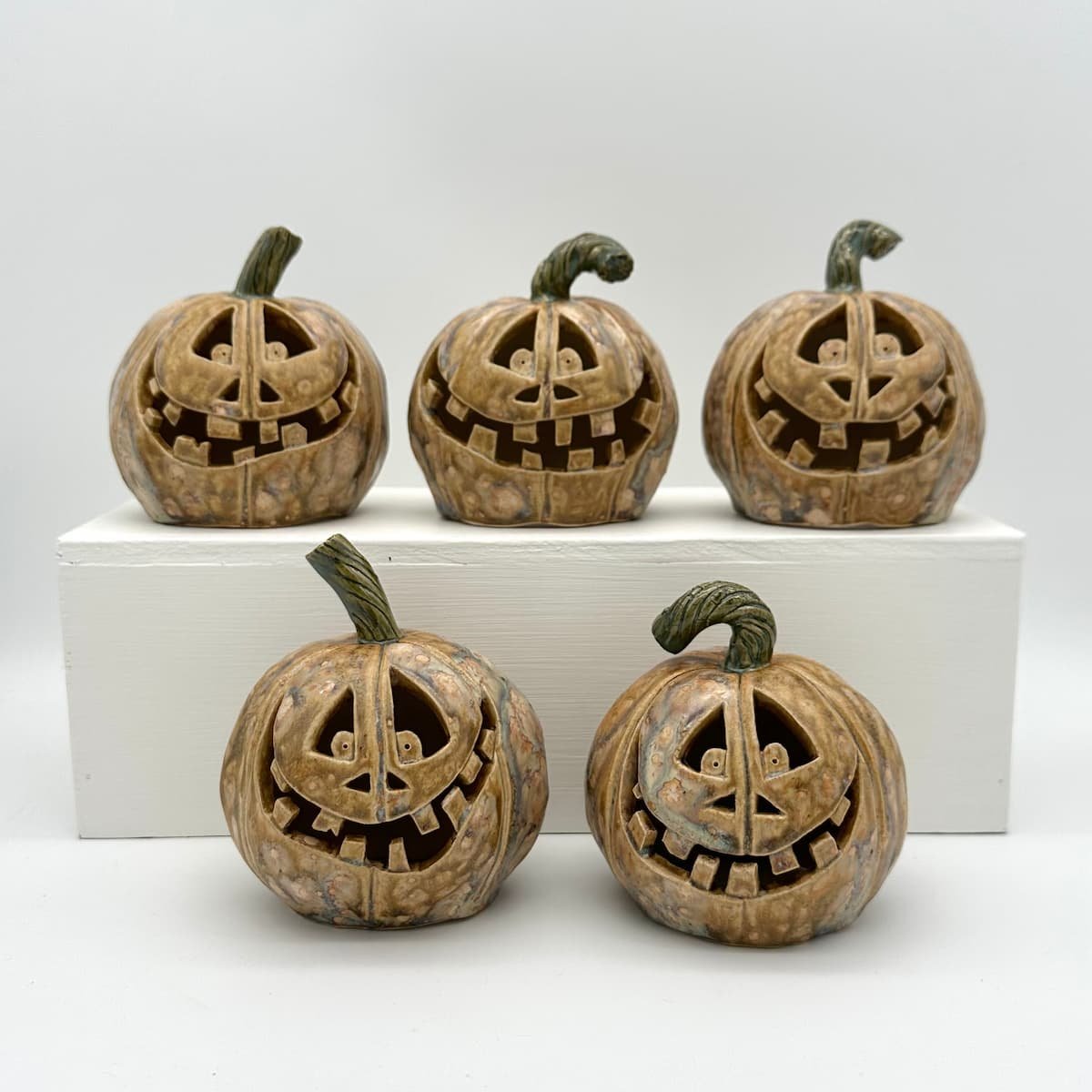 Carved ceramic pumpkin with battery tealight - group - daylight - Lucy Ormsby Pottery