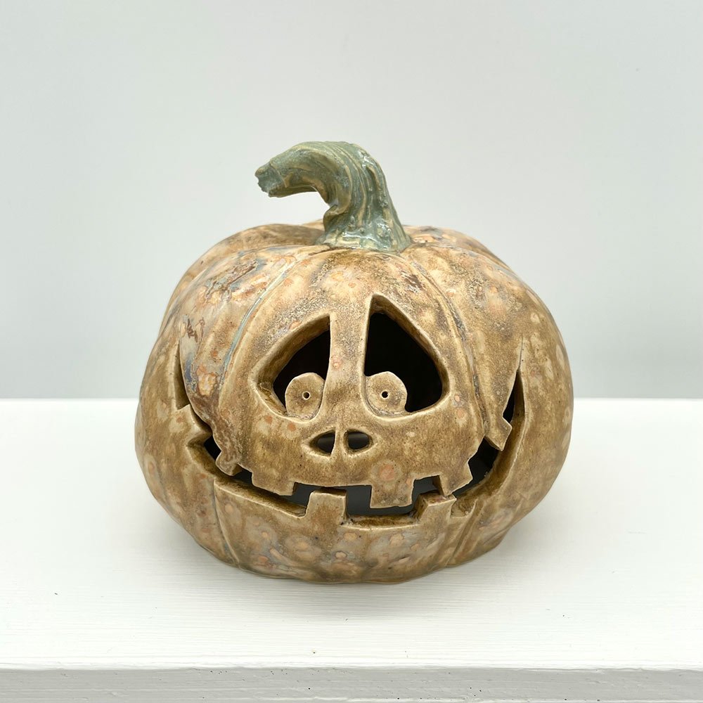 Carved ceramic pumpkin in white by Lucy Ormsby Pottery - from the front
