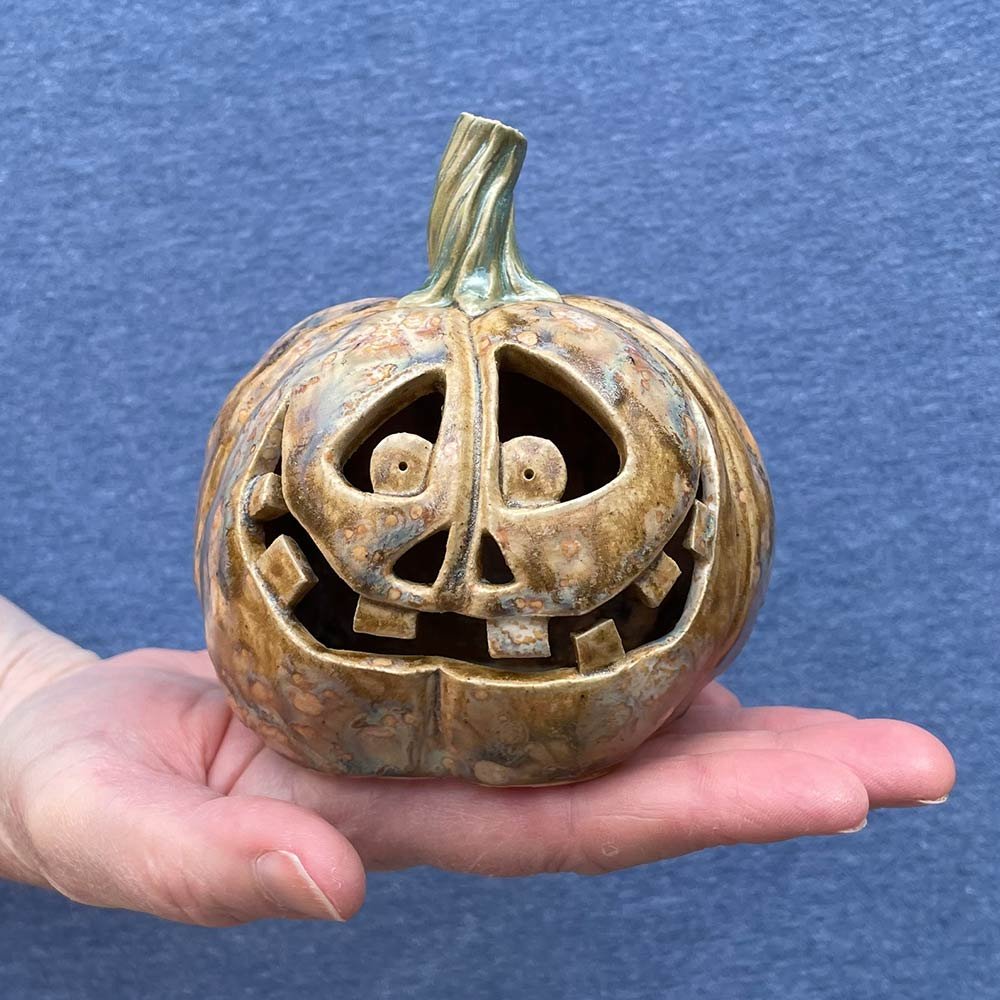 Carved ceramic pumpkin by Lucy Ormsby Pottery - in the hand