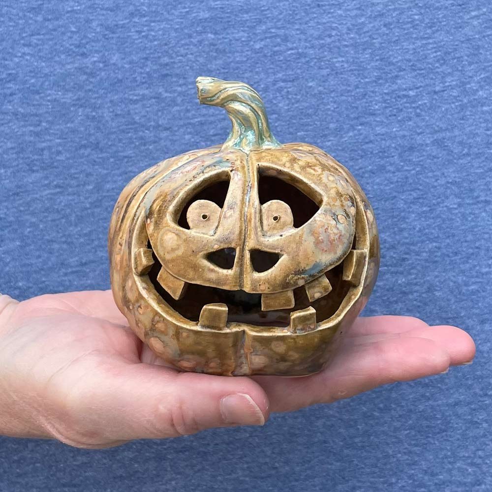 Carved ceramic pumpkin by Lucy Ormsby Pottery - in the hand