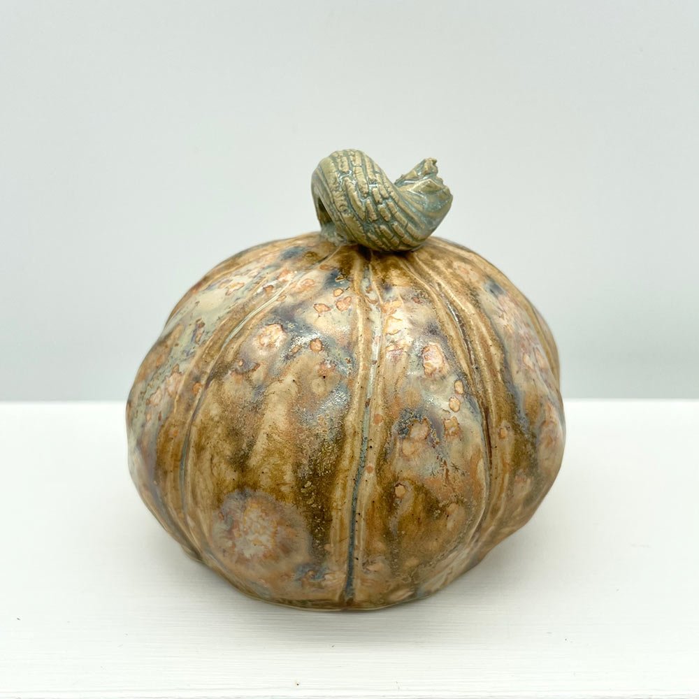 Carved ceramic pumpkin in white by Lucy Ormsby Pottery - from the back