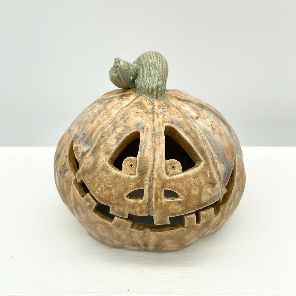 Carved ceramic pumpkin in white by Lucy Ormsby Pottery - from the front