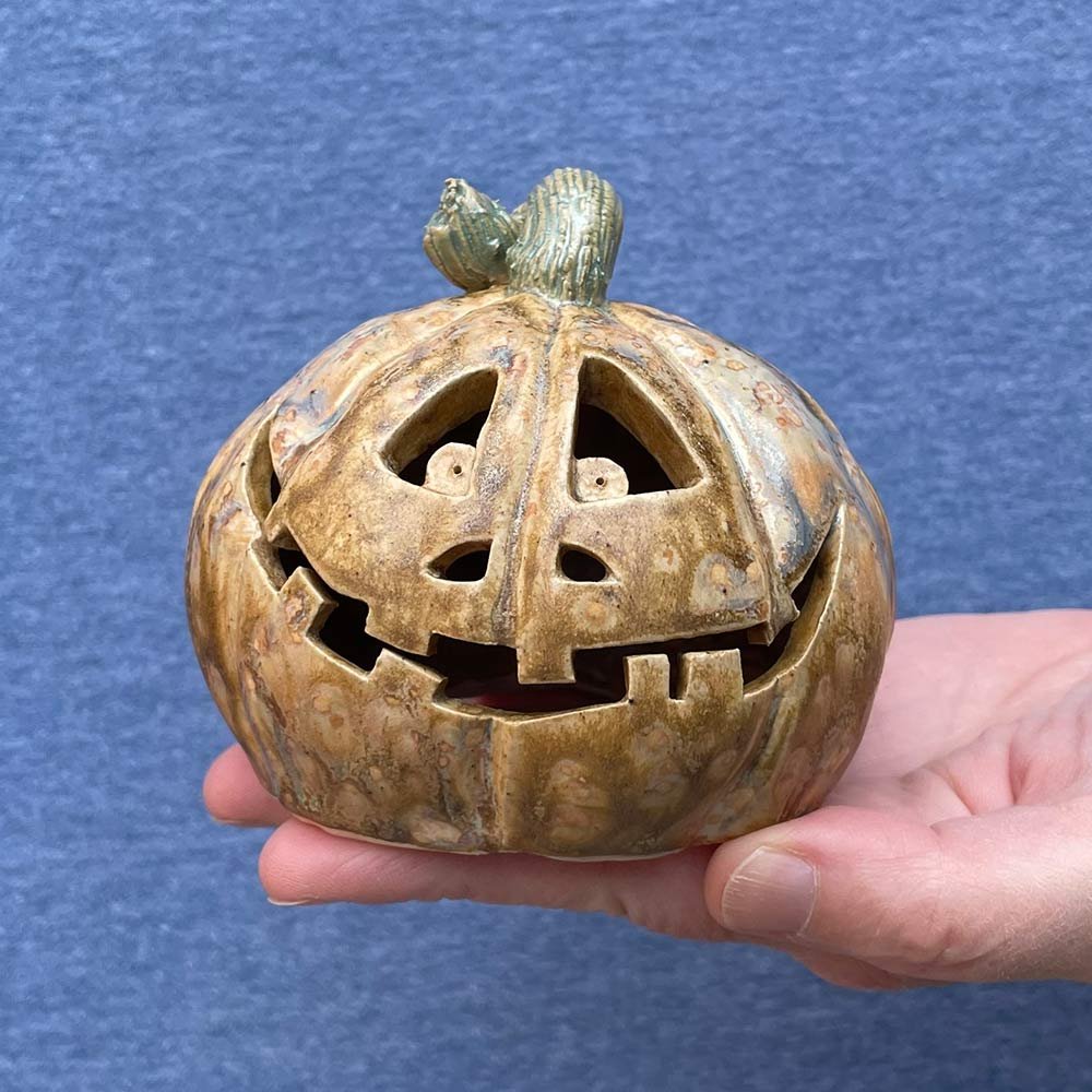 Carved ceramic pumpkin in white by Lucy Ormsby Pottery - in the hand