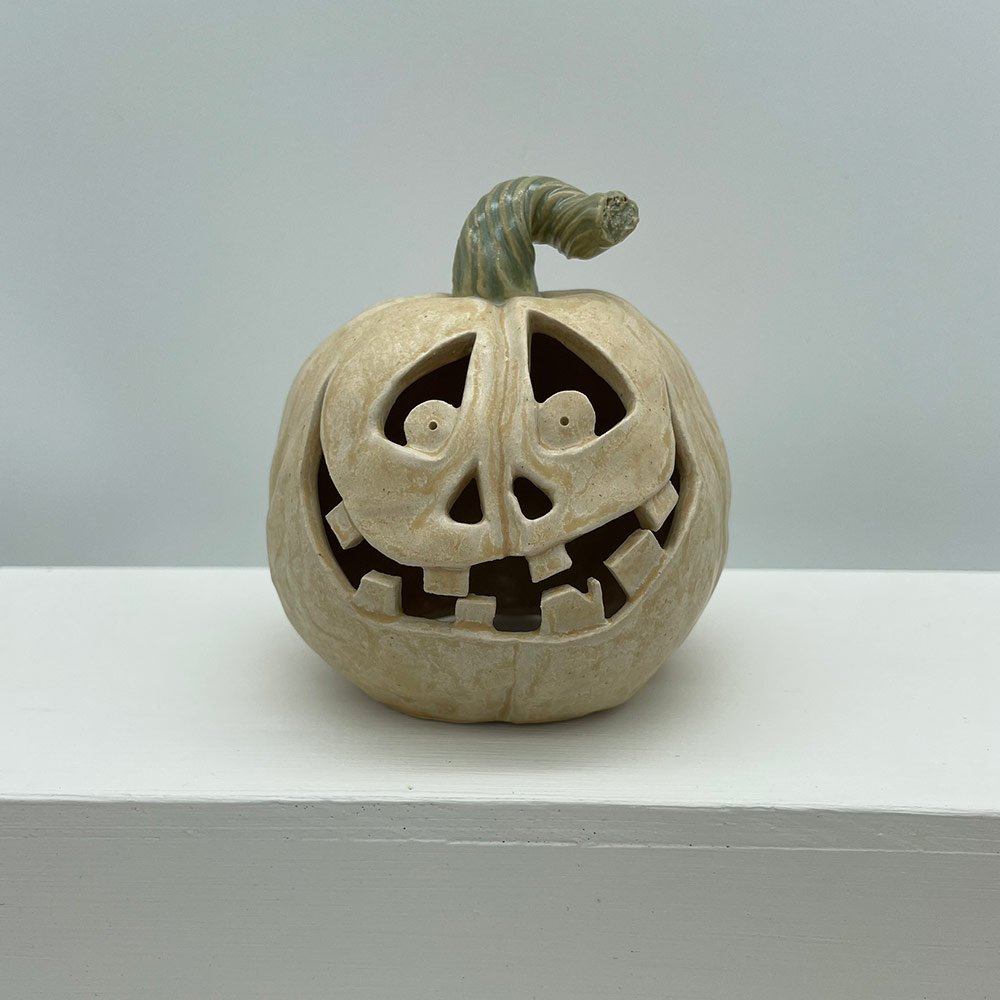 Carved ceramic pumpkin in white by Lucy Ormsby Pottery - from the front