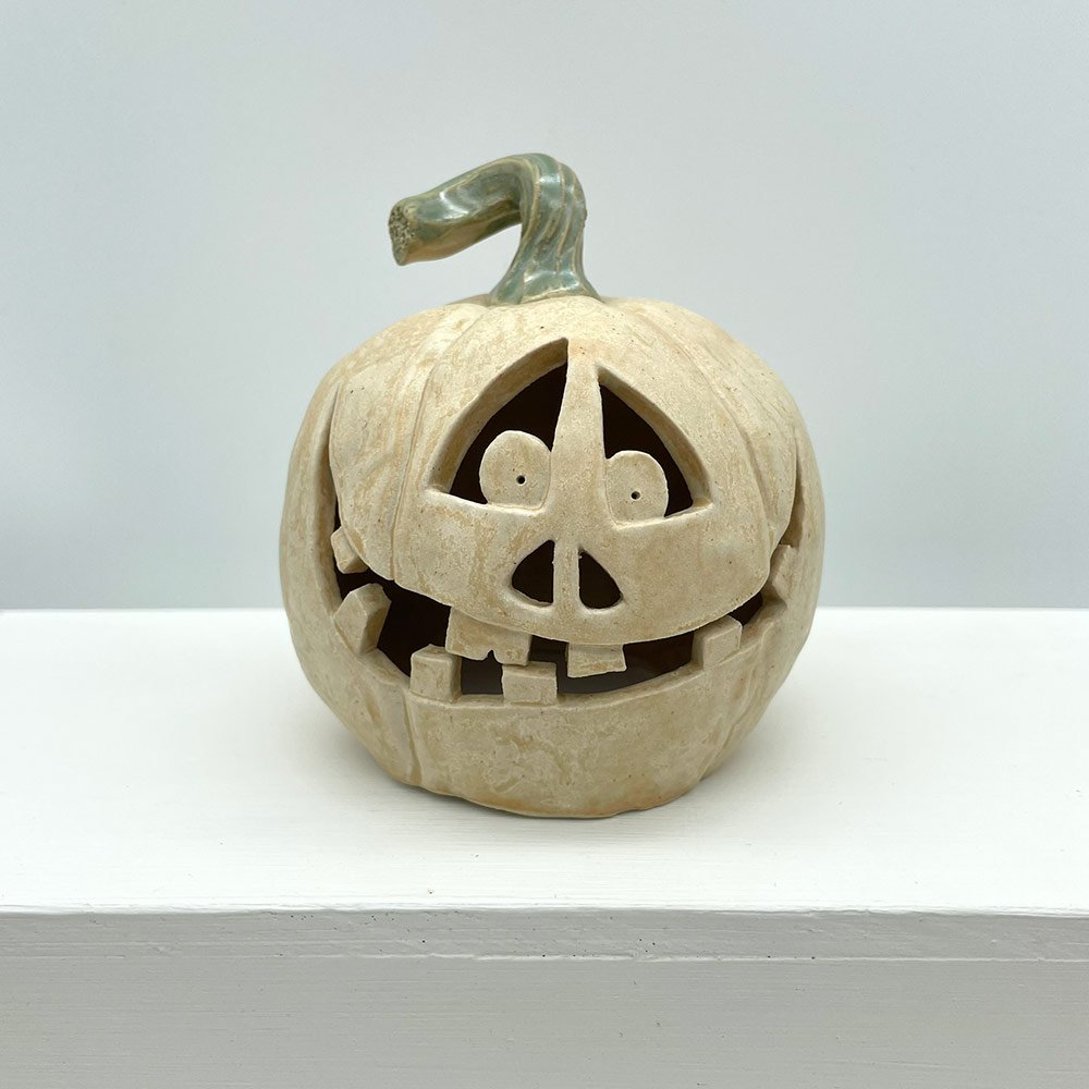 Carved ceramic pumpkin in white by Lucy Ormsby Pottery - from the front