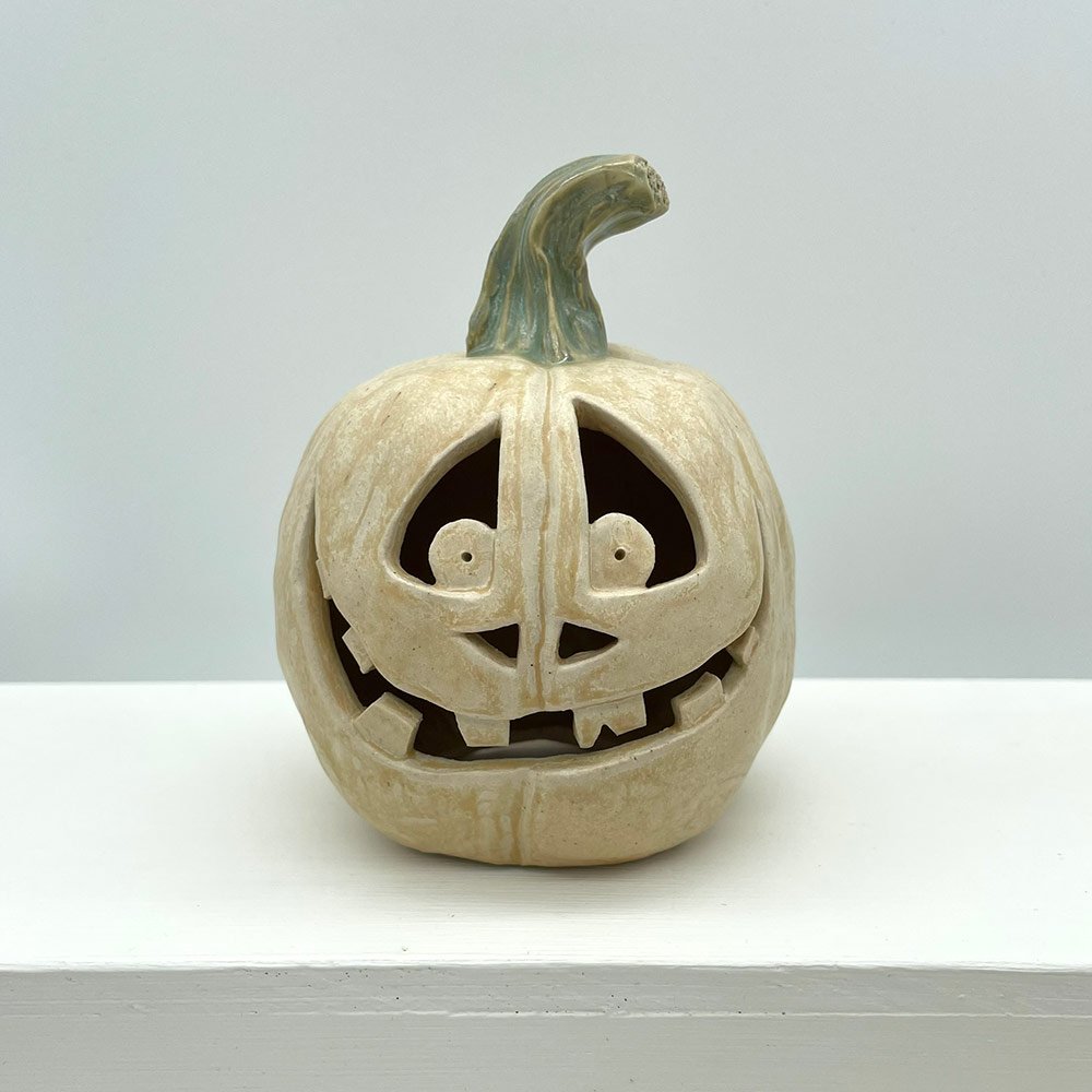 Carved ceramic pumpkin in white by Lucy Ormsby Pottery - from the front