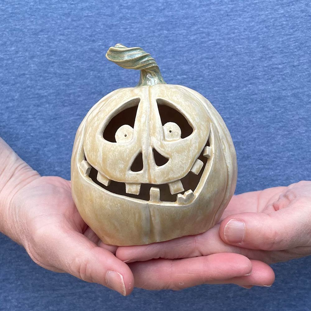 Carved ceramic pumpkin by Lucy Ormsby Pottery - in the hand