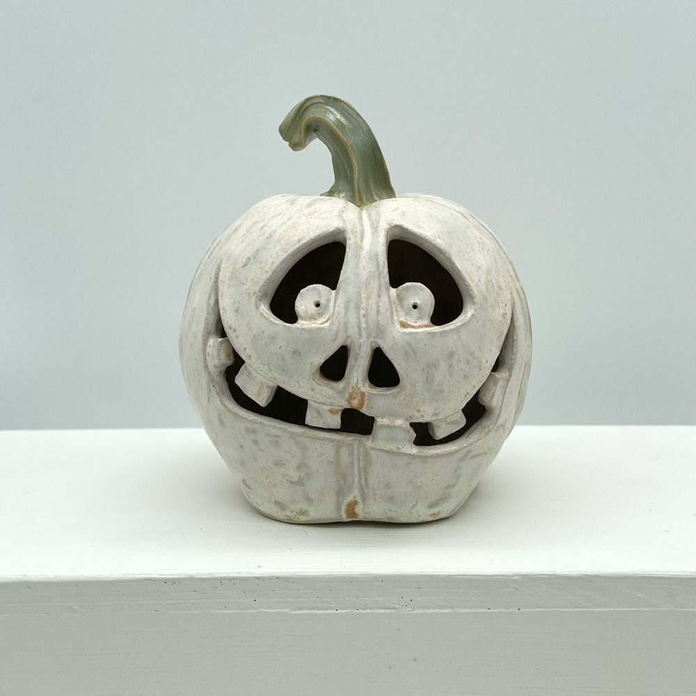 Carved ceramic pumpkin in white by Lucy Ormsby Pottery - from the front