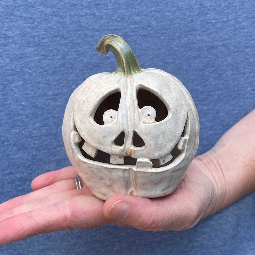 Carved ceramic pumpkin in white by Lucy Ormsby Pottery - in the hand