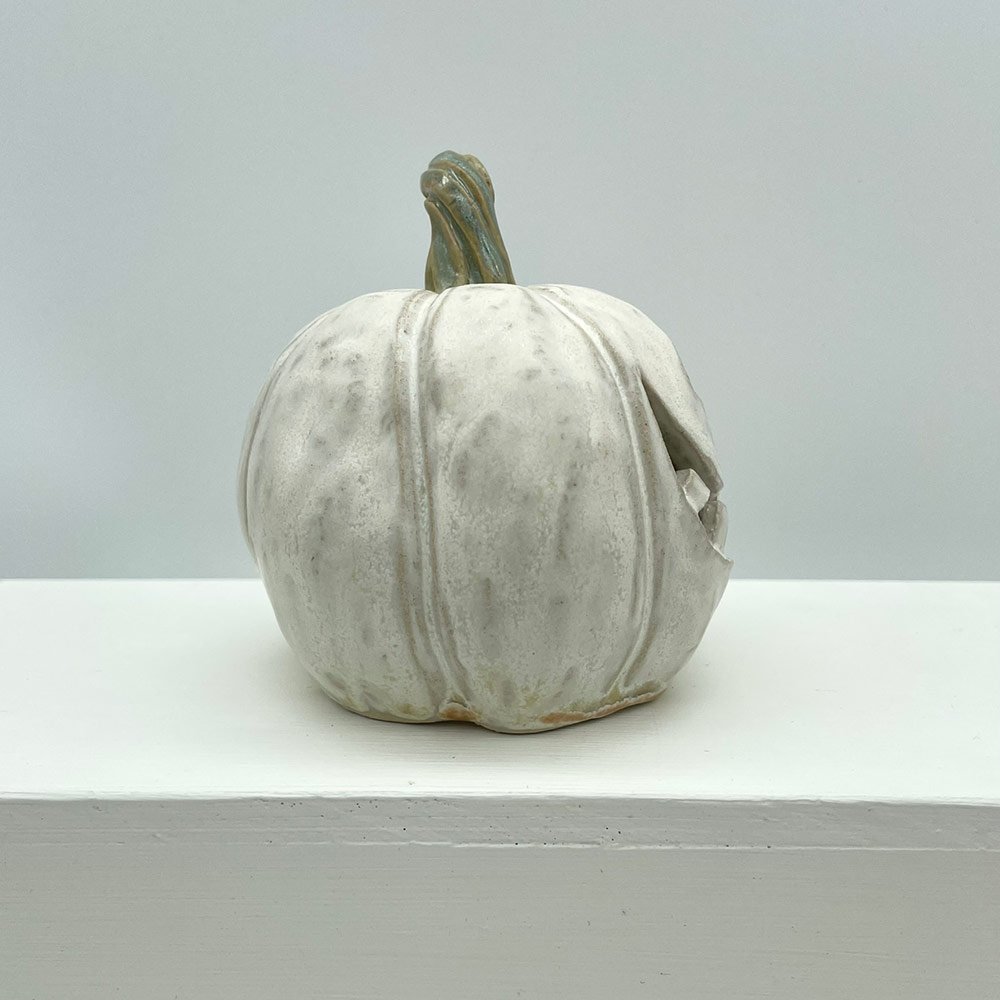 Carved ceramic pumpkin in white by Lucy Ormsby Pottery - from the side
