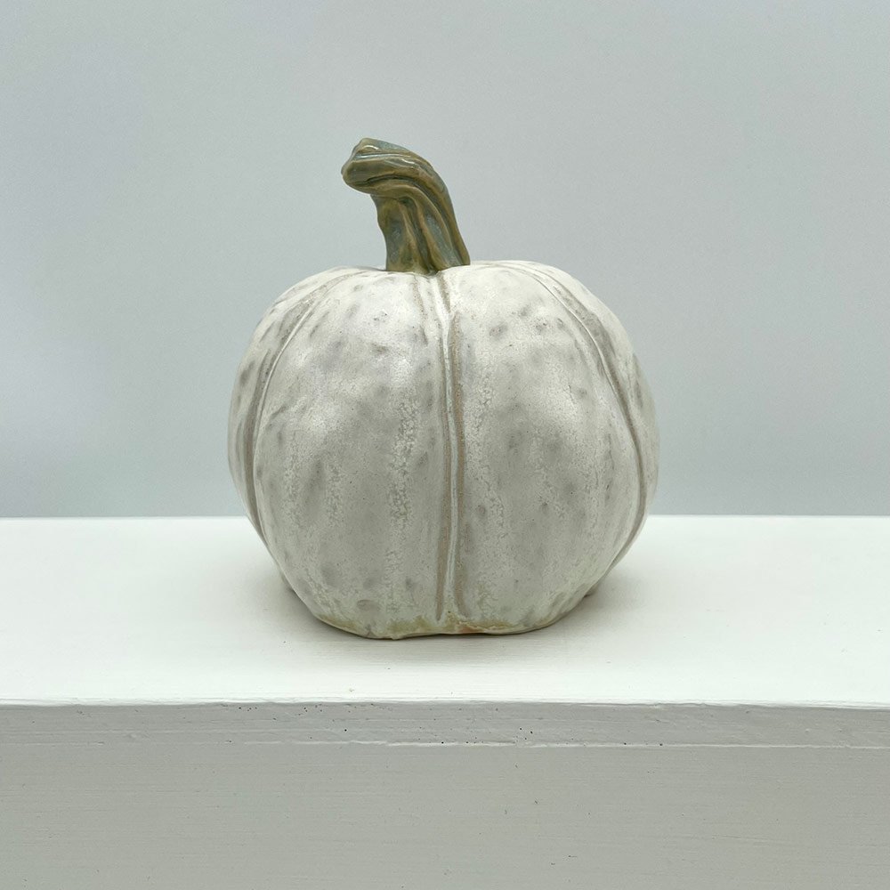 Carved white ceramic pumpkin by Lucy Ormsby Pottery from the back