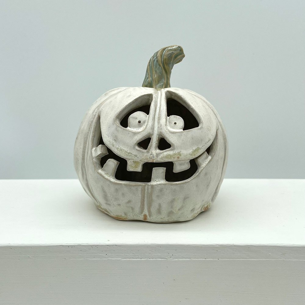 Carved ceramic pumpkin in white by Lucy Ormsby Pottery - from the front