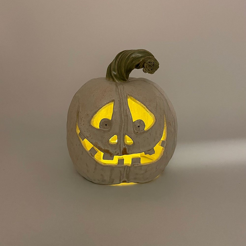 Carved ceramic pumpkin by Lucy Ormsby Pottery - lit up