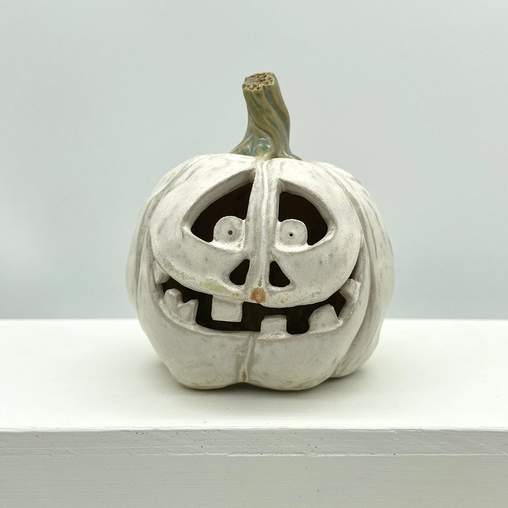 Carved ceramic pumpkin in white by Lucy Ormsby Pottery - from the front