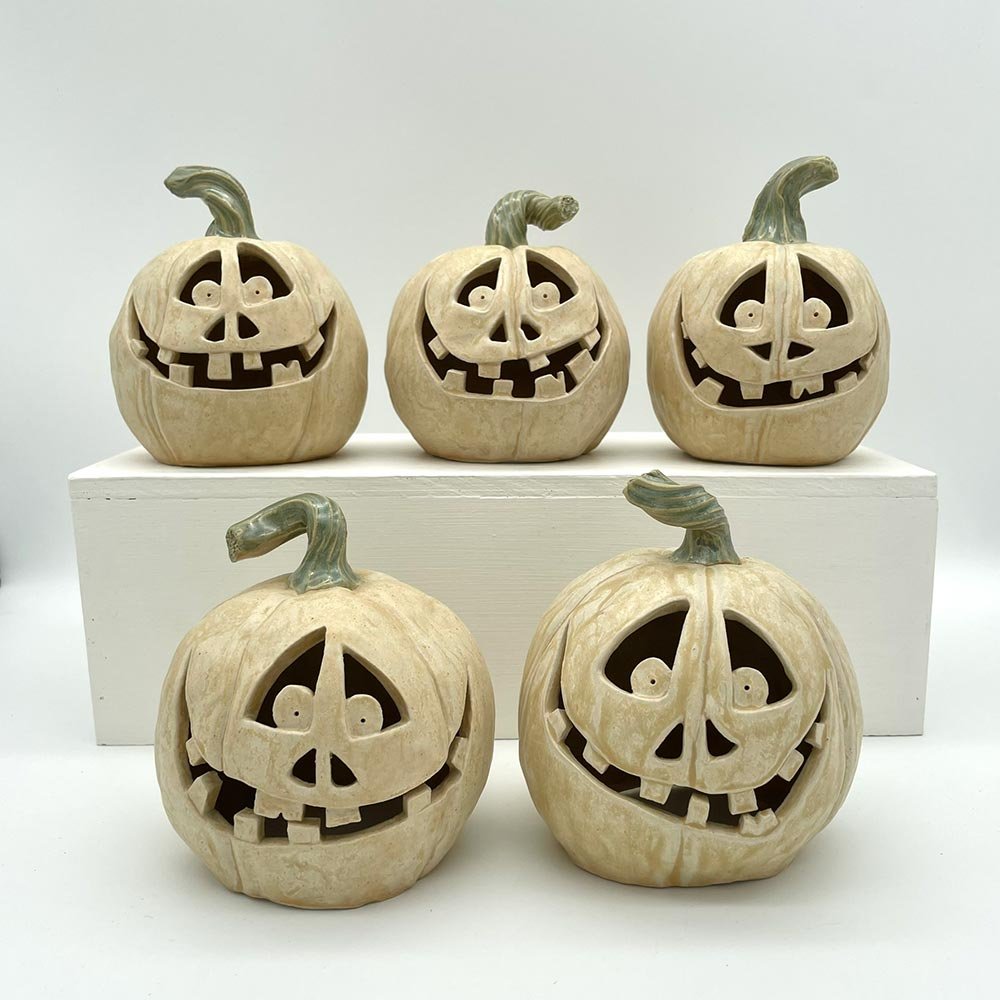 Group of carved ceramic pumpkins handmade by Lucy Ormsby Pottery