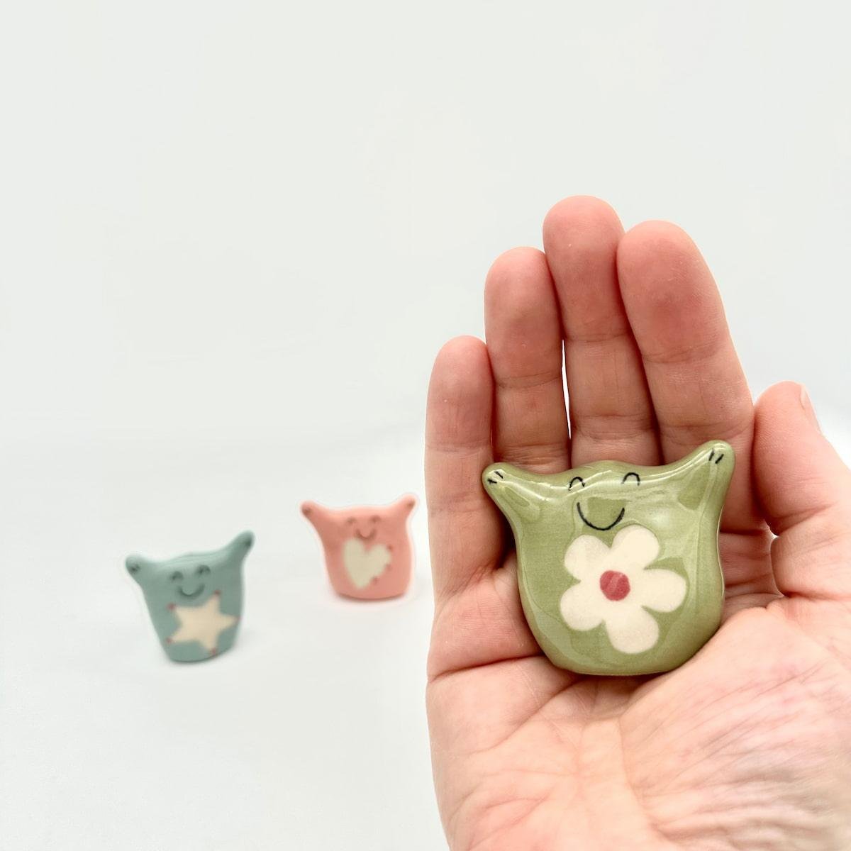 Trio of Hug Nuggets, green in hand